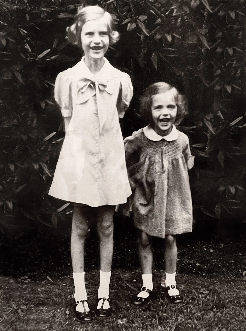 At five years old with big sister, Patti. Though I hated that dress, I’m giddy with excitement to have my picture taken.
